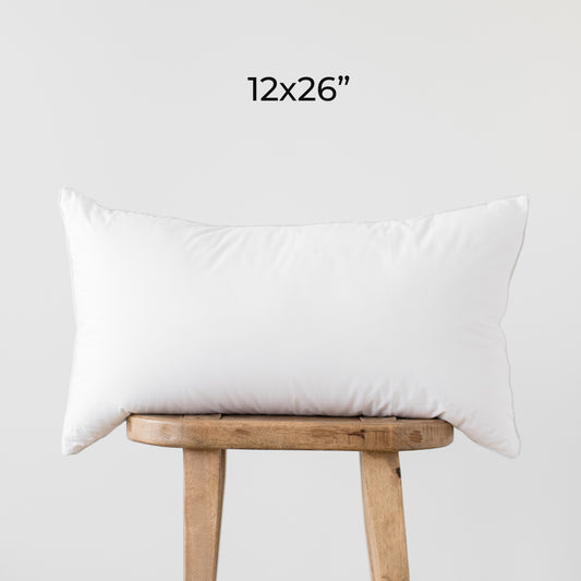 White rectangular faux down insert, 12x26 inches, displayed on wooden stool.
