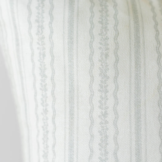 Cream and gray striped fabric with textured weave and decorative lace trim along the left edge.