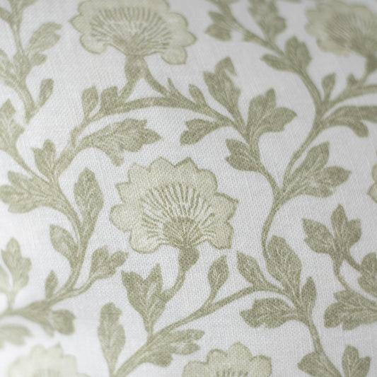Sage green floral and leaf pattern on cream linen fabric with textured weave.