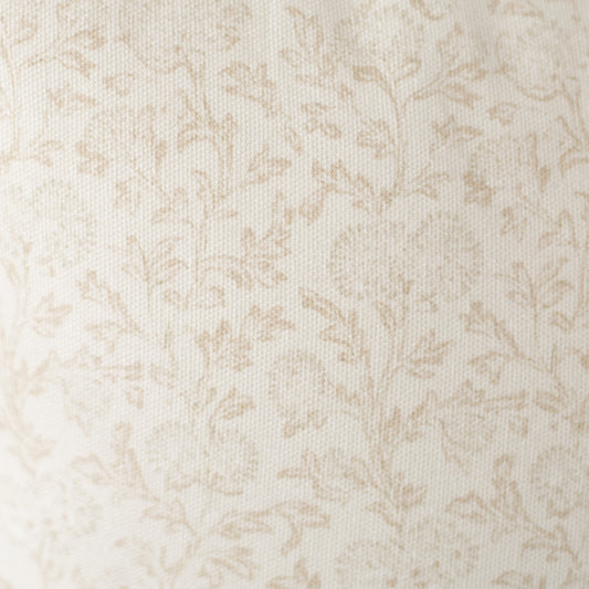 Cream and beige damask pattern on textured fabric surface.