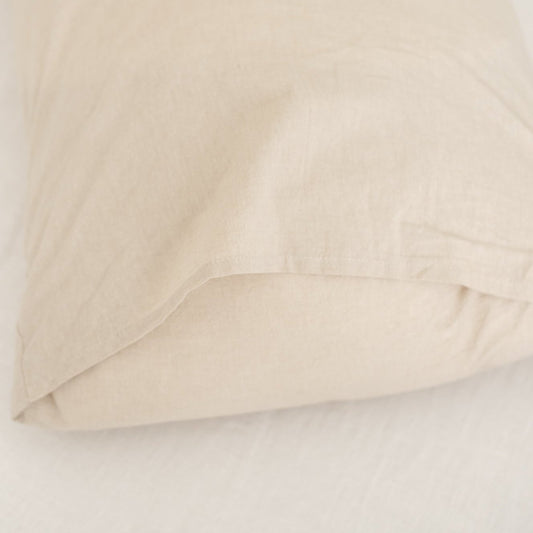 Beige duvet cover folded and layered, showing smooth fabric texture and neutral color.