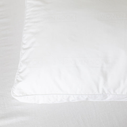 White faux down pillow insert with visible stitching and a smooth polyester cover.