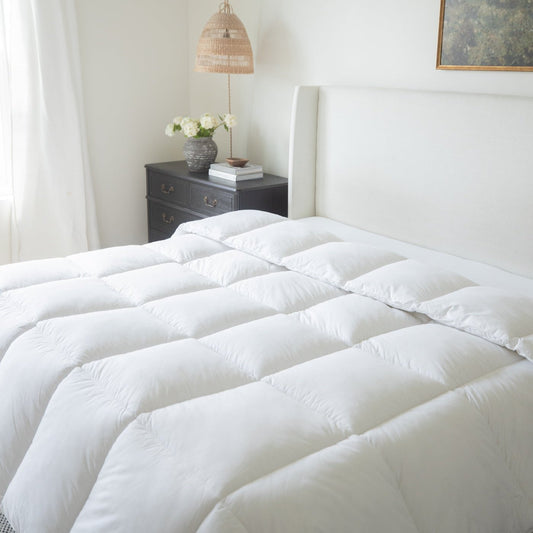 White quilted king duvet insert with box stitch pattern displayed on bed.