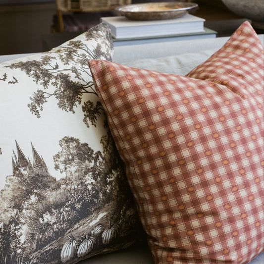 Pumpkin and cream plaid pillow with small pumpkin pattern throughout the woven fabric.