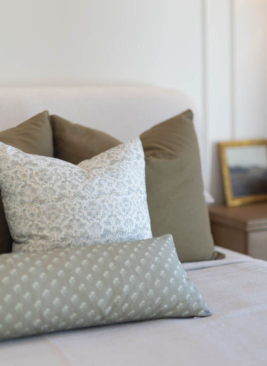 Three king pillow covers in neutral tones: one with damask pattern, one solid sage green, and one with white dot pattern on s