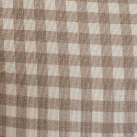 Tan and cream gingham check pattern on woven lumbar pillow fabric.