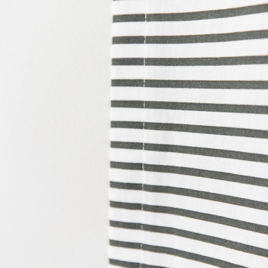 White curtain panel with evenly spaced horizontal gray stripes and center seam.