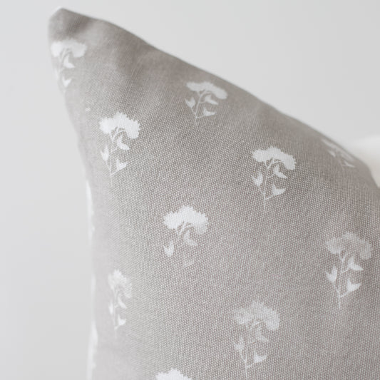Gray 18-inch pillow with white umbrella pattern repeat throughout fabric.