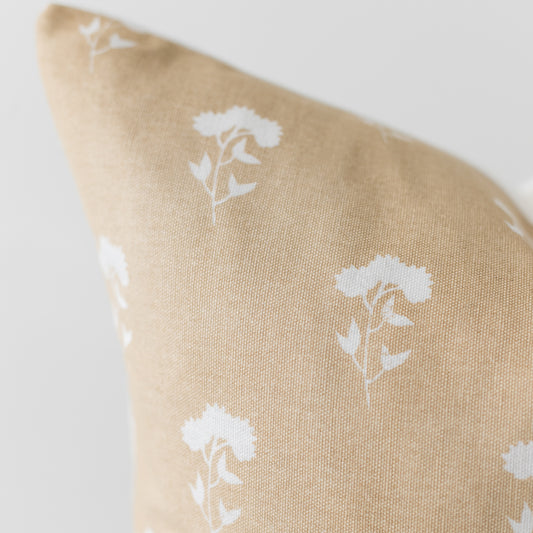 Beige linen pillow cover with white floral botanical print pattern.