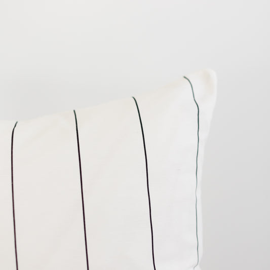 Cream-colored fabric with evenly spaced vertical pin stripes in black and gray tones.
