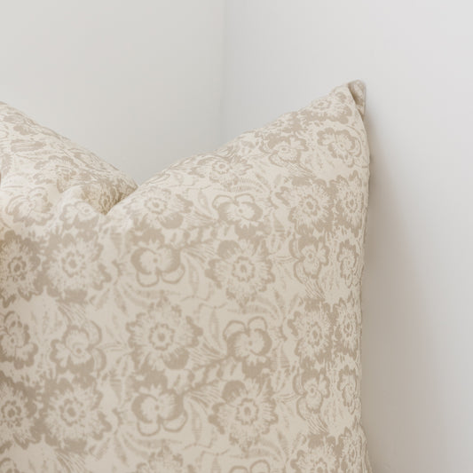 Cream pillow cover with taupe damask floral pattern, shown in corner detail view.