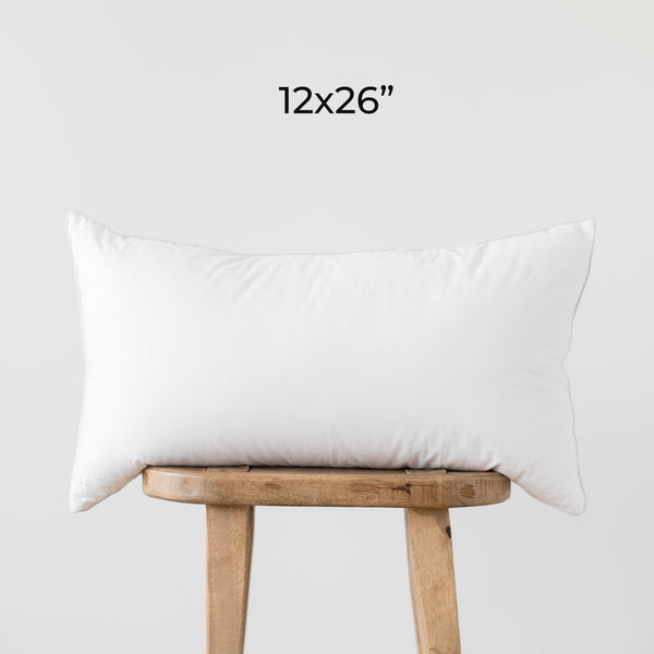 White rectangular faux down insert, 12x26 inches, displayed on wooden stool.
