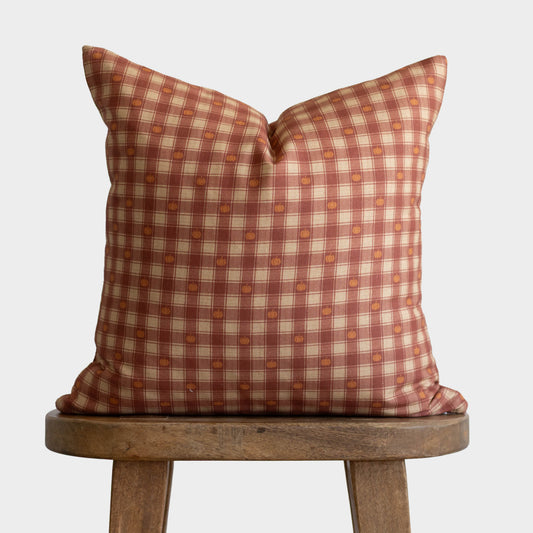 Pumpkin plaid throw pillow with red, cream, and orange checkered pattern with small pumpkin motifs.