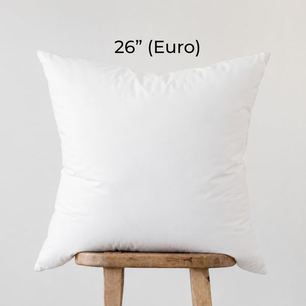 White square faux down insert pillow displayed on wooden stand, labeled 26" Euro size.