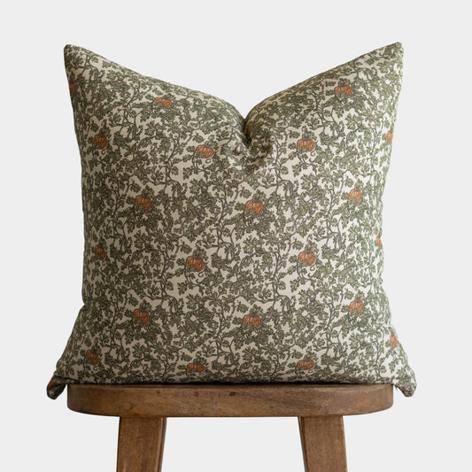 Hollow Grove patterned pillow cover with sage green foliage and rust-colored pomegranates on cream background.