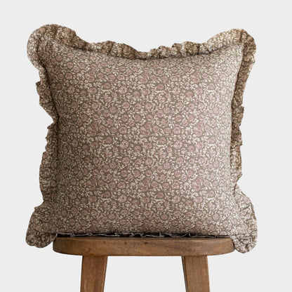 Beige and cream floral patterned square pillow with ruffled edges on all four sides.