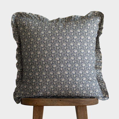 Decorative pillow with gray damask pattern and ruffled edges on all sides.