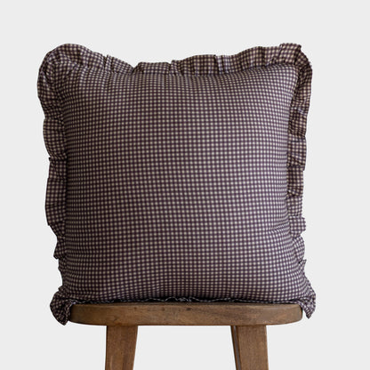 Plum gingham mini check pillow with ruffled edges on all sides, displayed on a wooden stool.