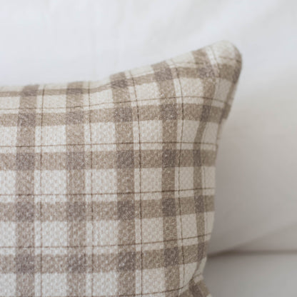 Beige and cream plaid cotton pillow with thick weave texture and rounded corner detail.