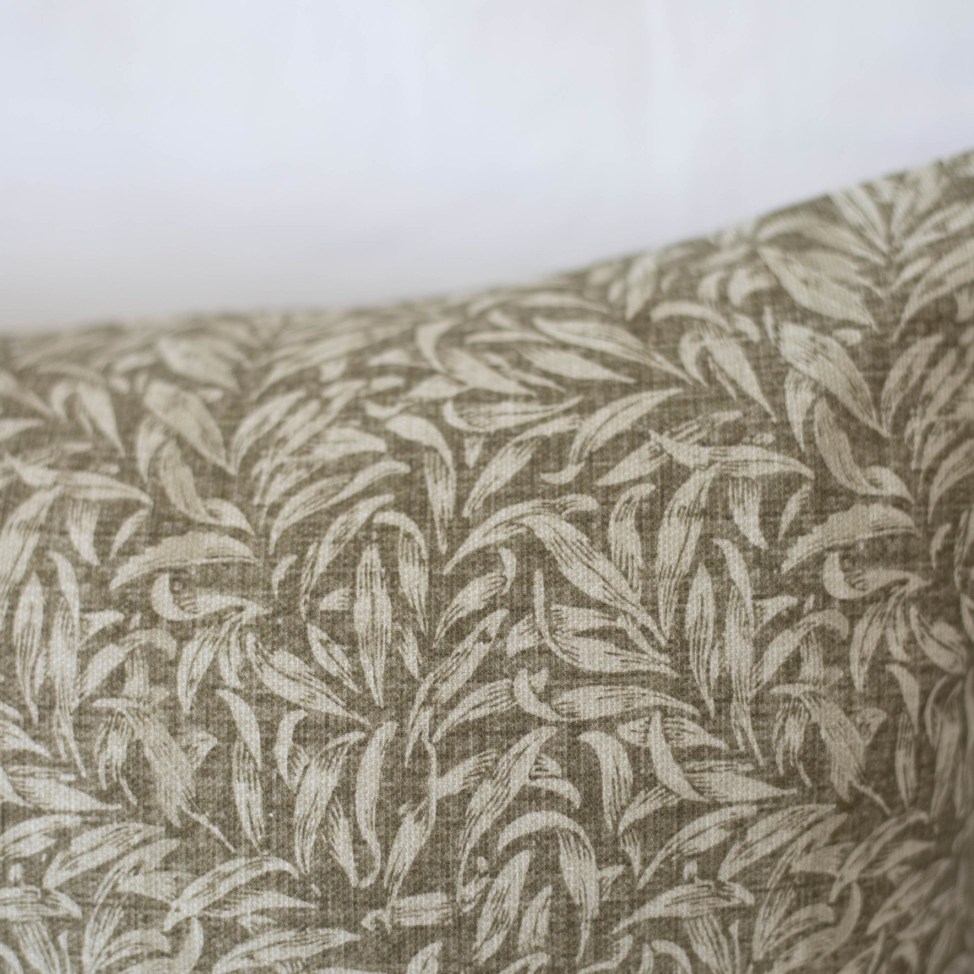 Beige and cream leafy pattern textile with woven texture detail.