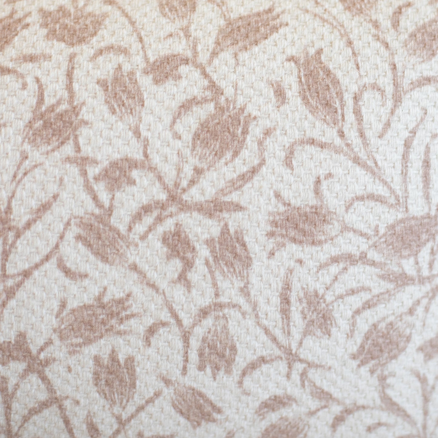 Beige and cream woven rug with taupe leaf pattern throughout.
