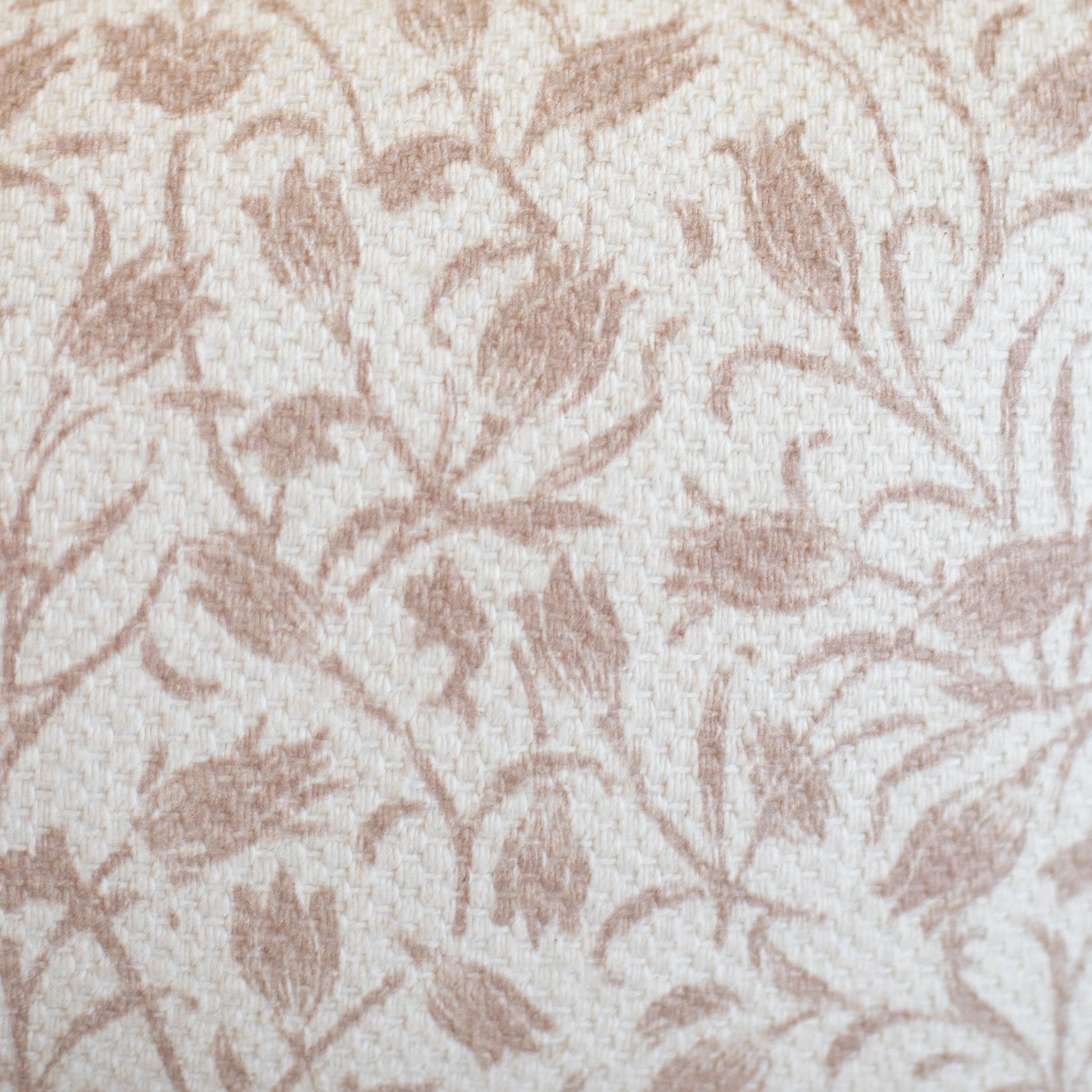 Beige and cream woven rug with taupe leaf pattern throughout.