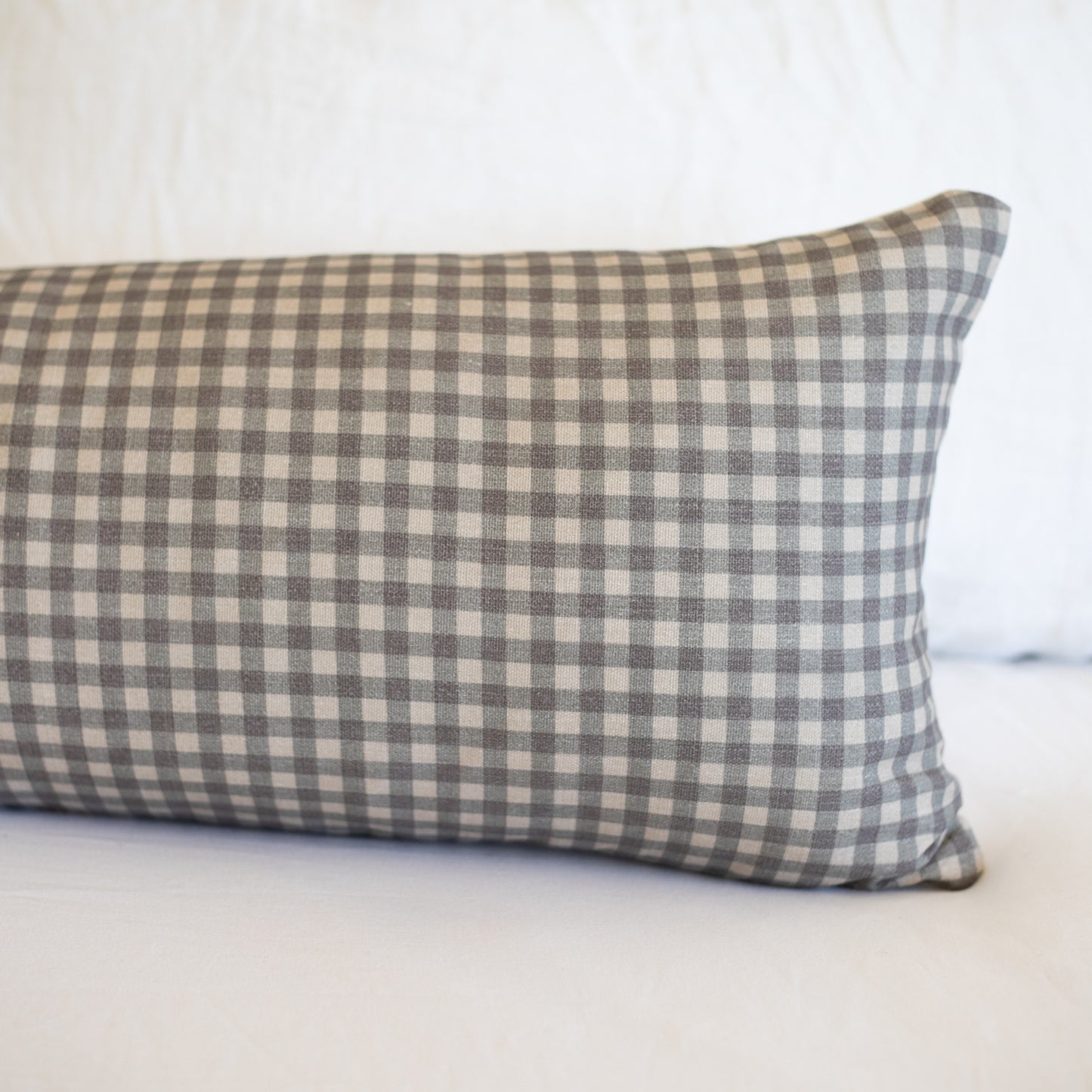 Brown and cream gingham patterned lumbar pillow with checkered weave fabric.