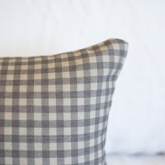 Brown and cream gingham patterned lumbar pillow with woven texture.