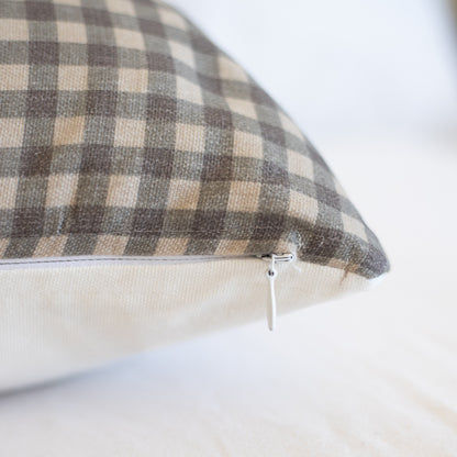 Brown and cream gingham plaid lumbar pillow with zipper closure on side.
