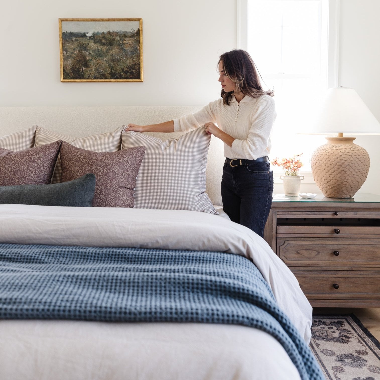 Storm blue waffle-textured blanket draped across a bed with white sheets.