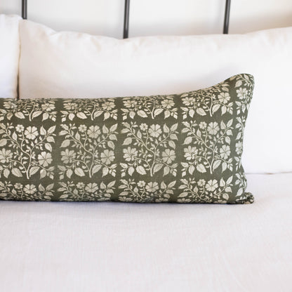 Rectangular lumbar pillow with sage green linen fabric featuring white floral and leaf pattern throughout.