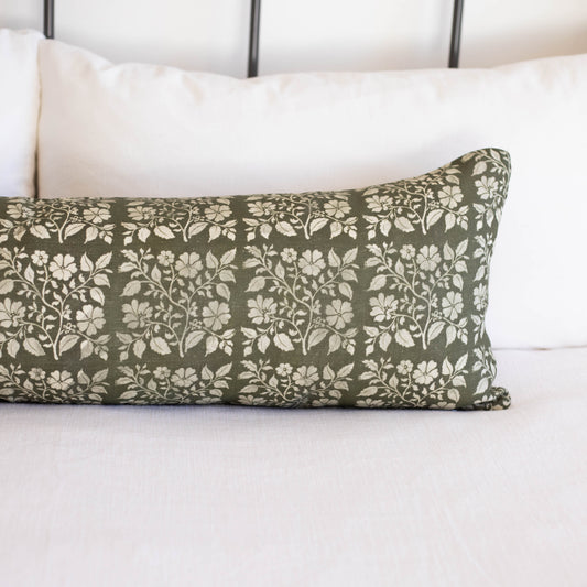 Rectangular lumbar pillow with sage green linen fabric featuring white floral and leaf pattern throughout.