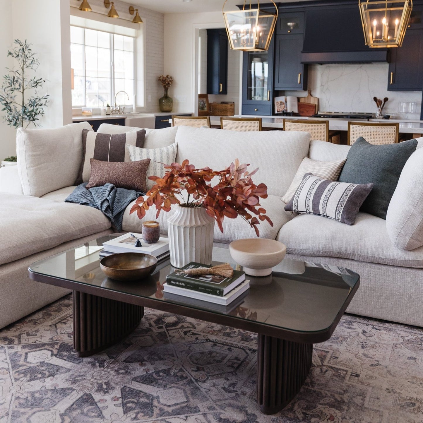 Colette lumbar pillow in taupe with horizontal stripe detail displayed on cream sectional sofa.