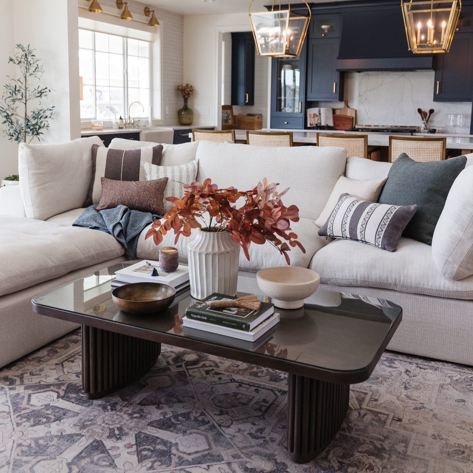 Colette lumbar pillow in taupe with horizontal stripe detail displayed on cream sectional sofa.