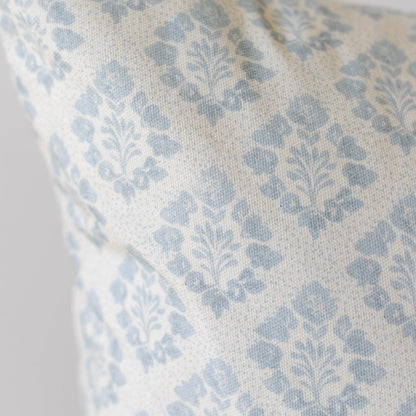 Blue and cream damask patterned pillow cover with woven fabric texture.
