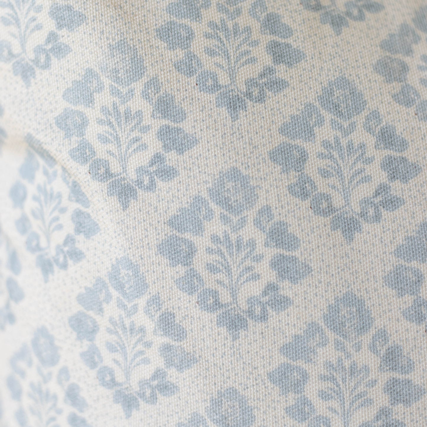 Blue and cream damask patterned pillow cover with woven texture.