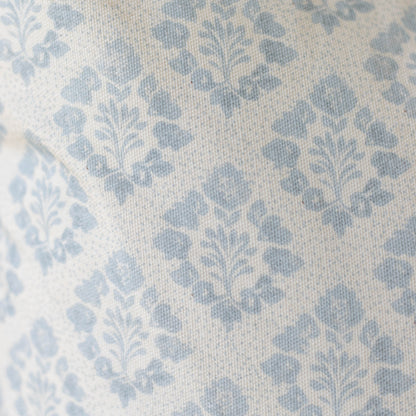 Blue and cream damask patterned pillow cover with woven texture.