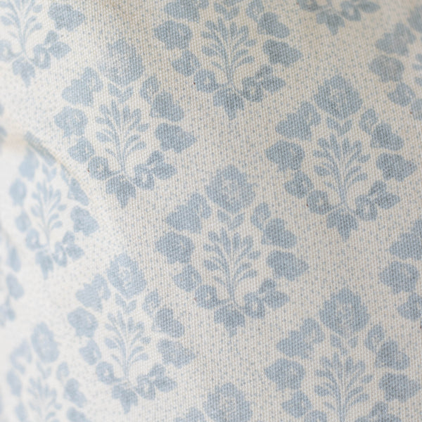 Blue and cream damask patterned pillow cover with woven texture.