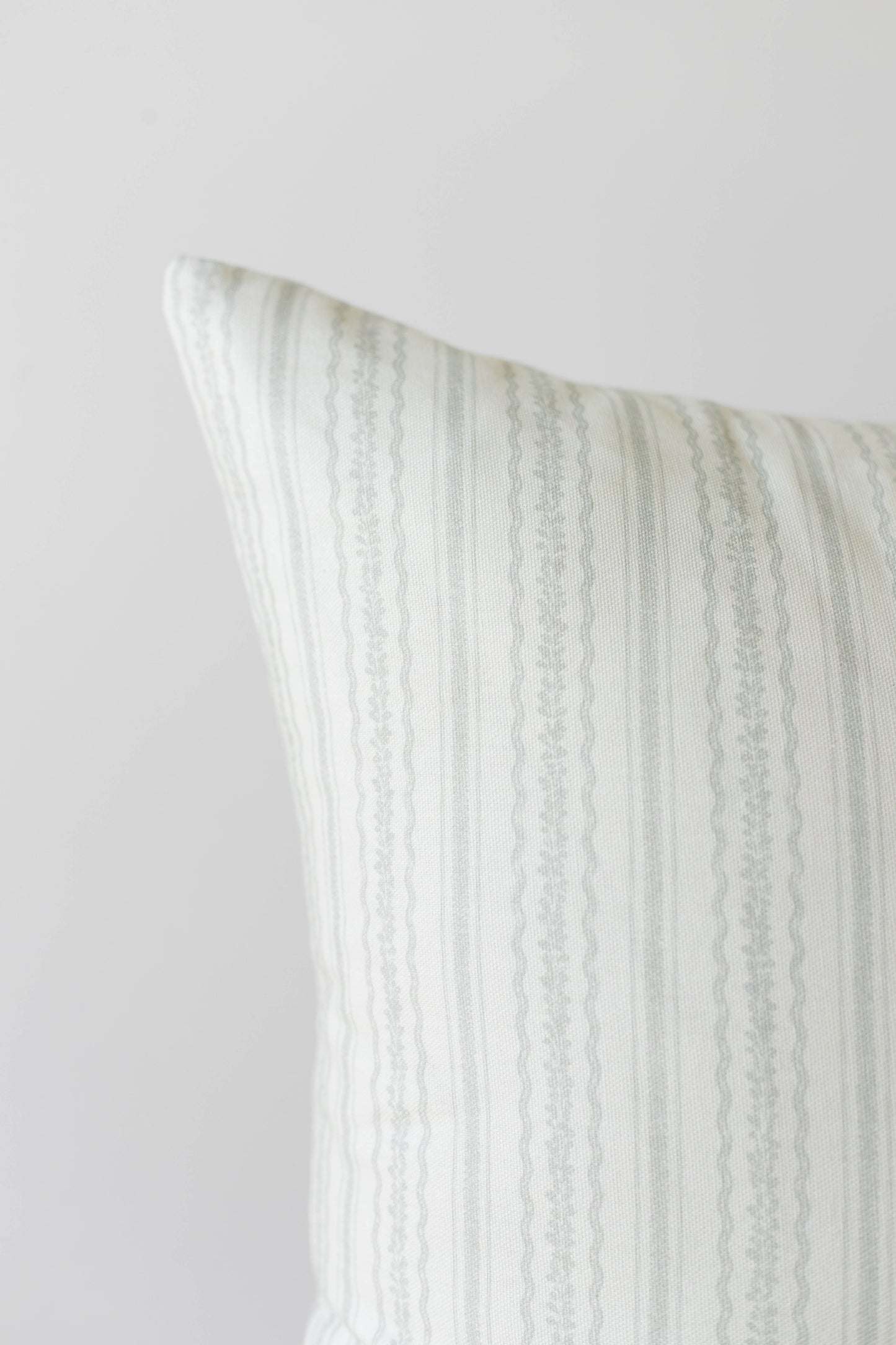 Cream and beige striped pillow cover with vertical woven texture pattern.