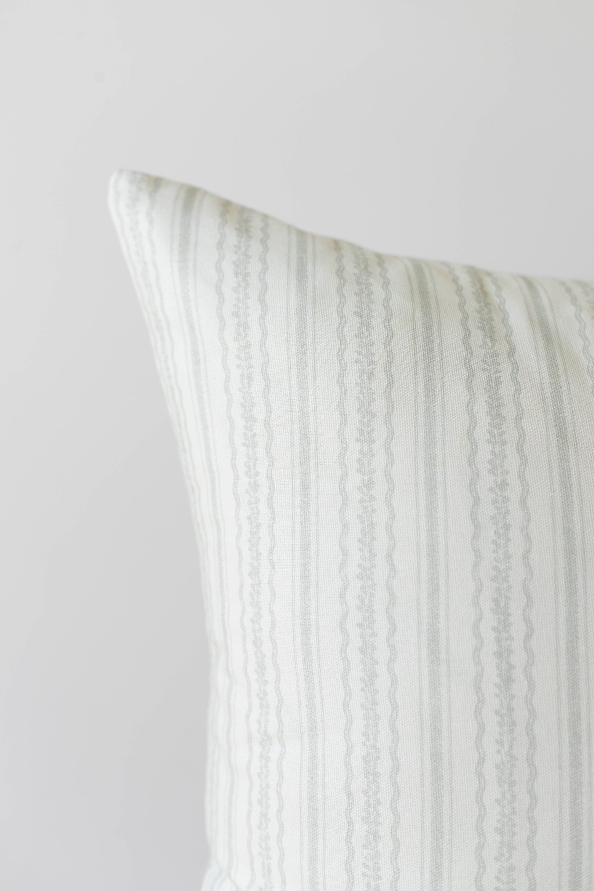 Cream and beige striped pillow cover with vertical woven texture pattern.