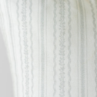Cream and gray striped fabric with textured weave and decorative lace trim along the left edge.