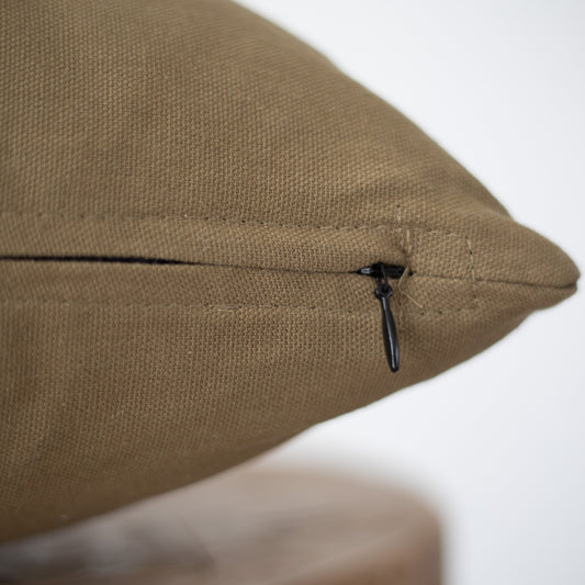 Taupe linen pillow cover with dark drawstring closure on side seam.