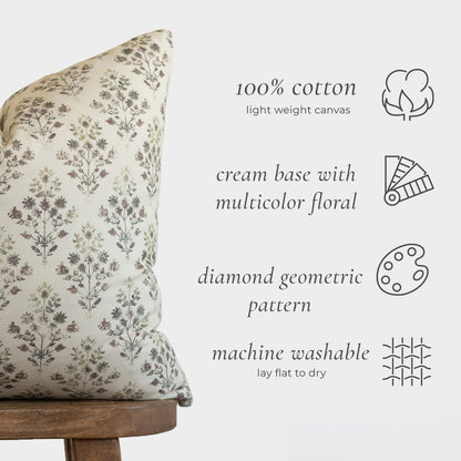 Cream pillow with multicolor floral and geometric diamond pattern in 100% cotton canvas.