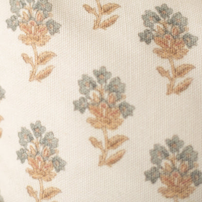 Cream fabric with repeating botanical pattern of flowers in sage green, coral, and tan with brown stems and leaves.