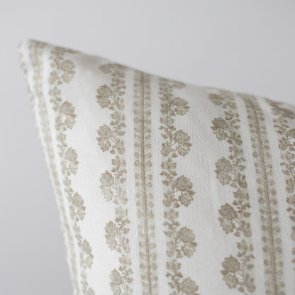 Cream linen pillow with tan damask pattern and vertical stripes, angled corner view.