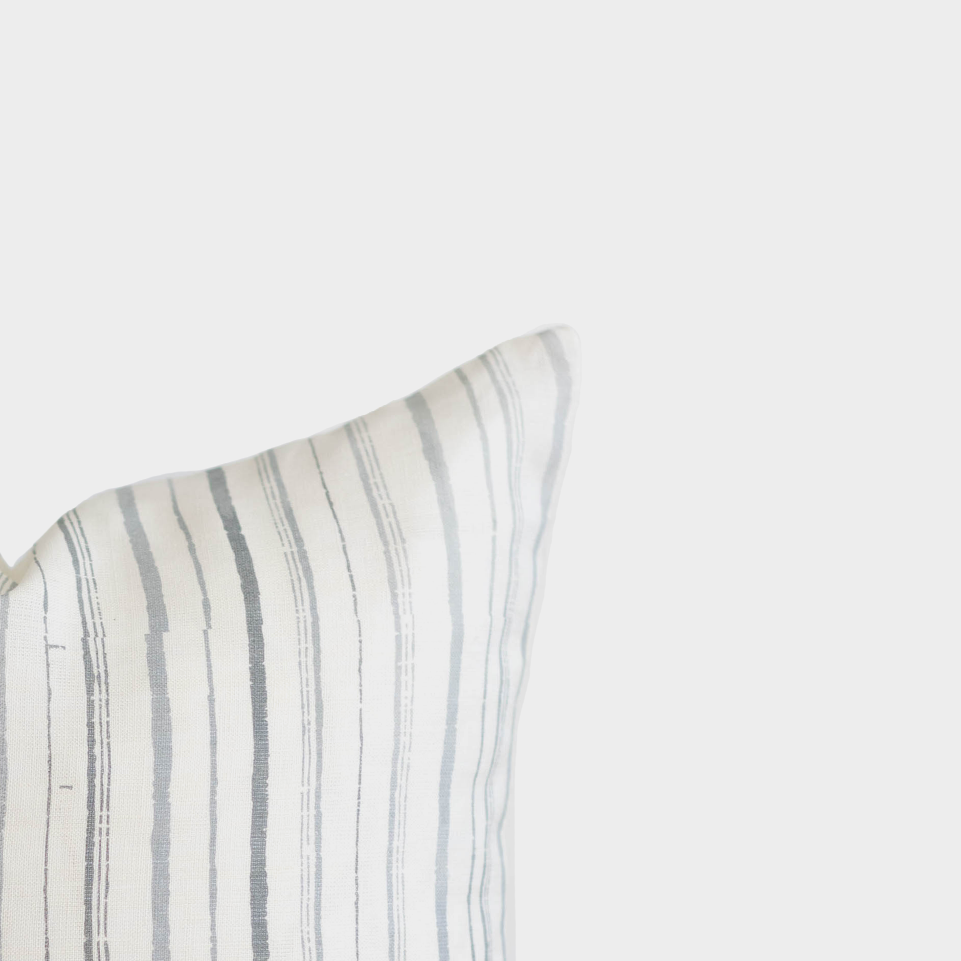 Rectangular linen pillow with gray and white vertical stripes in 18" x 22" dimensions.