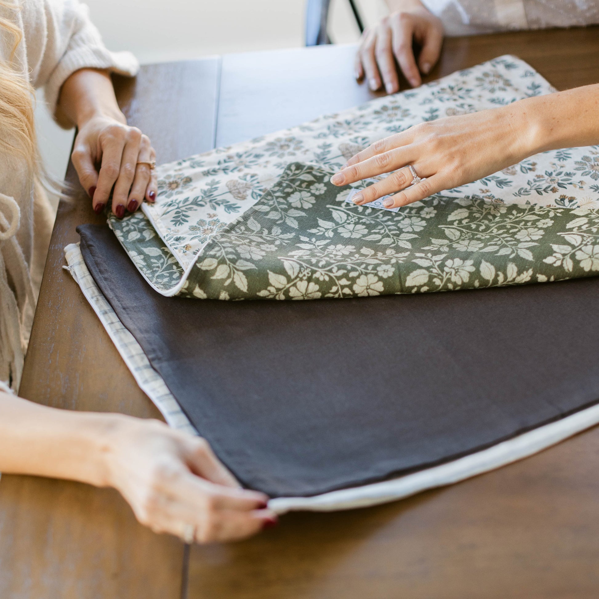 Double-sided cushioned mat with floral pattern on one side and solid gray on the other.