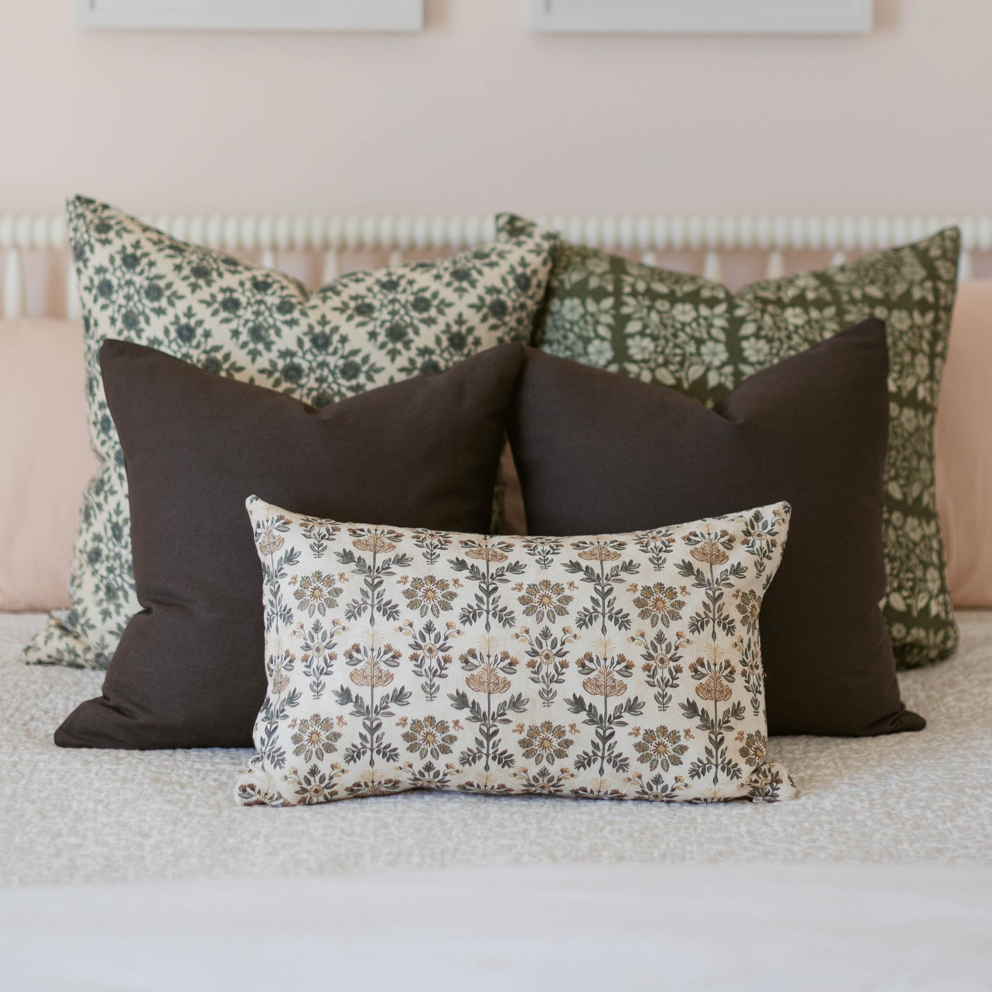 Three double-sided decorative pillows with floral and solid patterns in sage, charcoal, and cream.