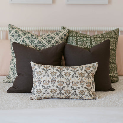 Three double-sided decorative pillows with floral and solid patterns in sage, charcoal, and cream.