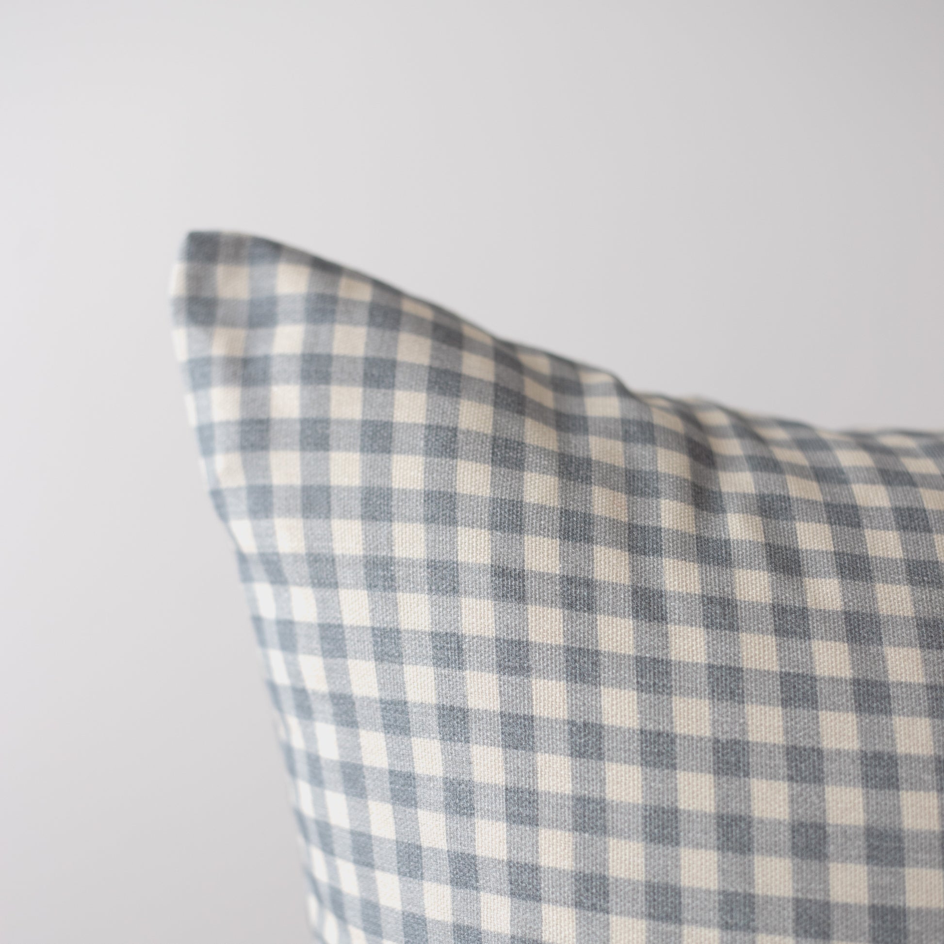 Dusty blue and cream gingham plaid pillow cover with woven texture.